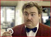 John Candy with curtain ring in scene from Planes, Trains and Automobiles