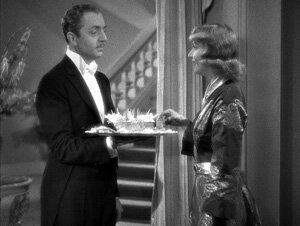 In his new role as butler, Godfrey (Powell) serves his employer,Irene (Lombard).